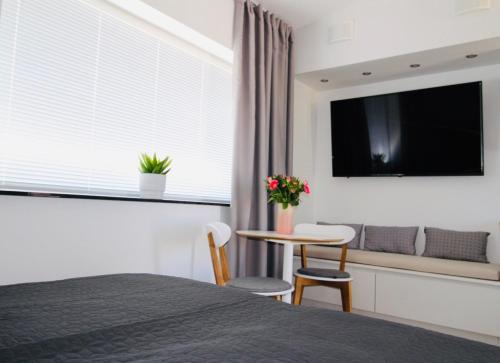 a bedroom with a bed and a table and a window at Easy Livin' Apartment Hotel in Växjö