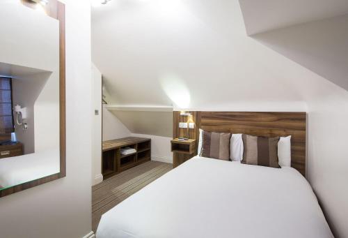 سرير أو أسرّة في غرفة في Heathrow-Windsor Guest House