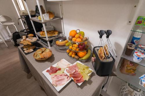 a table with many different types of food on it at Al Qatta Bed & Breakfast in Canicattì
