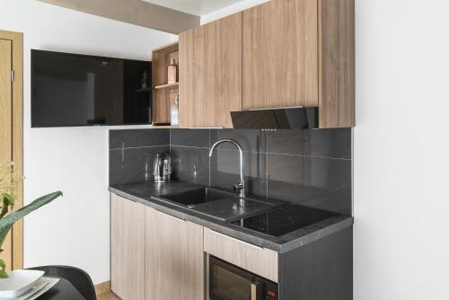 a kitchen with a sink and a counter at Nowa Dana Ośrodek Wypoczynkowy in Łebcz