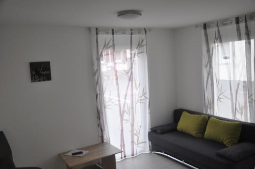 a living room with a couch and a window at Kiefer-Apartments in Rust