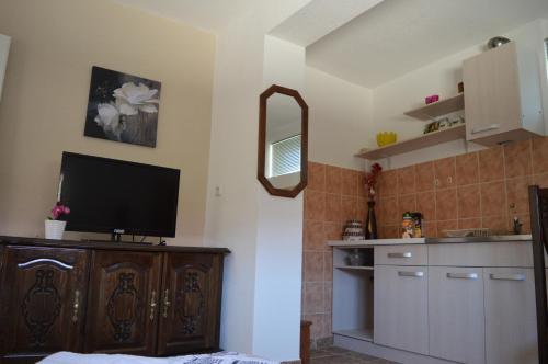 a kitchen with a flat screen tv on a cabinet at Villa Marija in Ohrid