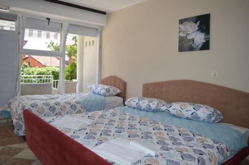 a bedroom with two beds and a window at Villa Marija in Ohrid