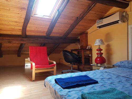 a bedroom with a bed and a desk and a chair at Sweet Apartment Bianchini in Bologna