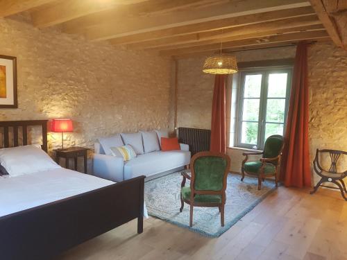 Postelja oz. postelje v sobi nastanitve Le Moulin du Bourg