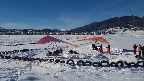 a group of people standing in the snow with a kite at villa in mountains in Bakuriani