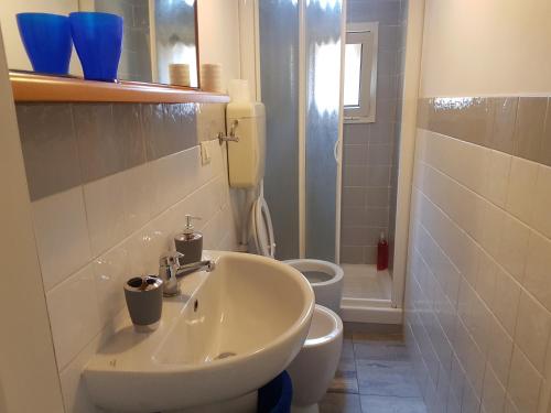 a bathroom with a sink and a toilet at Sweet Apartment Bianchini in Bologna