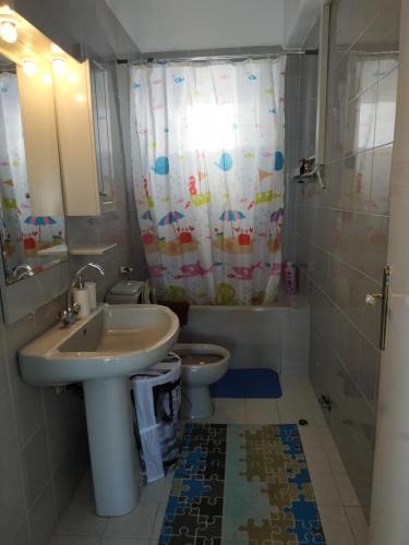 a bathroom with a sink and a toilet at Beachfront Eva's House in Karianí