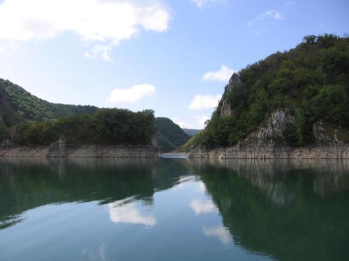 a large body of water with mountains in the background at Guest house Pribojska Banja in Pribojska Banja