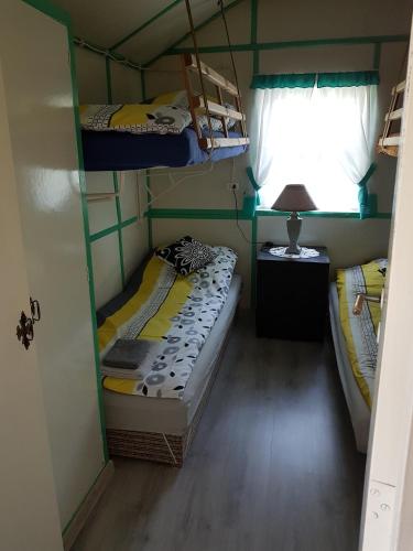 a room with two bunk beds and a window at Leszkowo in Ustka