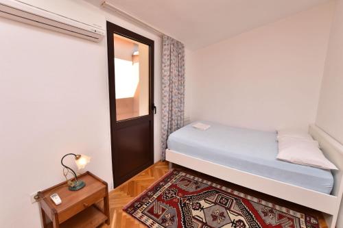 プリモシュテンにあるApartment Frieskeの小さなベッドルーム(ベッド1台、ドア付)