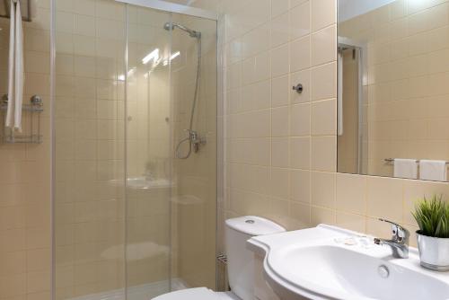 a bathroom with a shower and a toilet and a sink at Casa dos Cortes in Sever do Vouga
