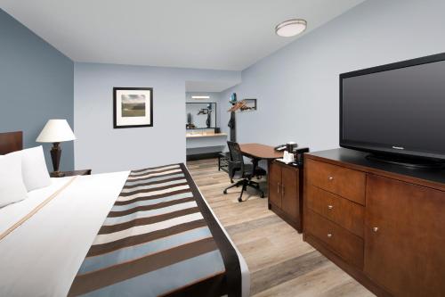 a hotel room with a bed and a flat screen tv at Ivy City Hotel in Washington, D.C.