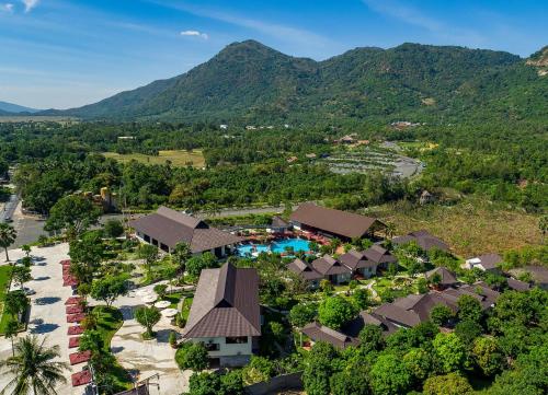 an aerial view of the resort with mountains in the background at Sang Như Ngọc Resort in Chau Doc