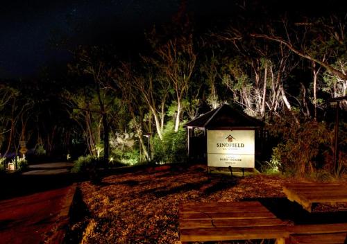 a sign in the middle of a park at night at Sinofield Edu-Retreat in Leura