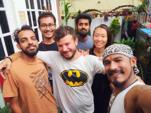 a group of men posing for a picture with a woman at Yog Hostel- Rooftop Yoga & Backpacker Social Stay in Thamel, Kathamndu in Kathmandu