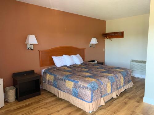 a hotel room with a bed and two lamps at Orbits Inn in Somerset