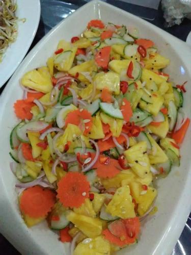 a plate of salad with vegetables on a table at Hotel Seri Malaysia Mersing in Mersing
