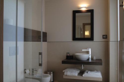 a bathroom with a sink and a glass shower at Albergo Nicolin in Lecco