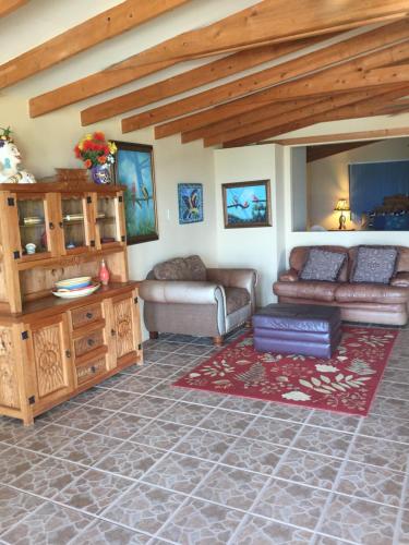 a living room with a couch and a table at Ocean Front Baja Vacation in Rosarito