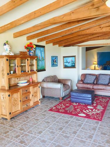 a living room with a couch and a table at Ocean Front Baja Vacation in Rosarito