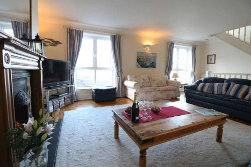 a living room with a couch and a coffee table at The Old Quayside House in Falmouth