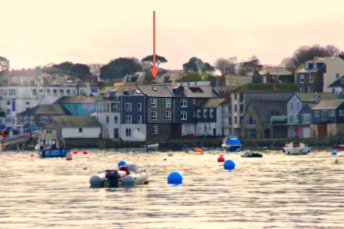 a group of boats in the water near a town at The Old Quayside House in Falmouth