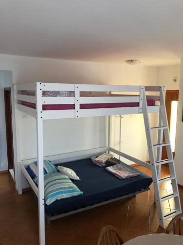 a bedroom with two bunk beds and a ladder at Arcobaleno isolano in Izola