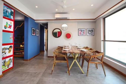 a dining room with a wooden table and chairs at Theory9 Premium Service Apartments Khar in Mumbai