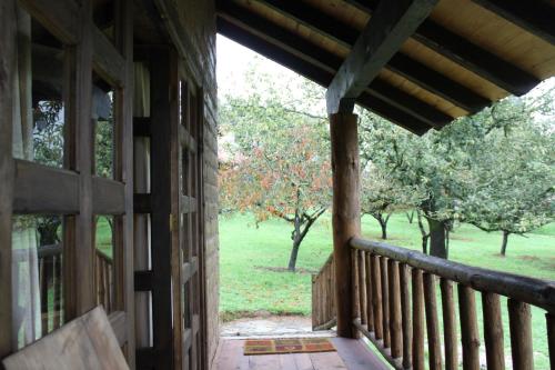 a porch of a house with a view of a field at La Tierra Grande in Zacatlán