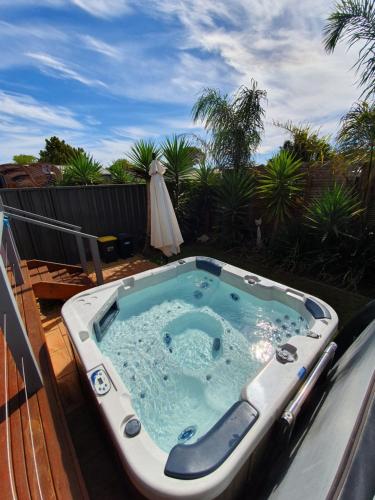 a jacuzzi tub on top of a deck at Seagrass Villas Normanville in Normanville