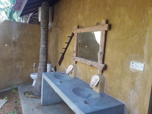 a bathroom with a sink and a toilet at Kitelantis Hotel and Resort in Kalpitiya