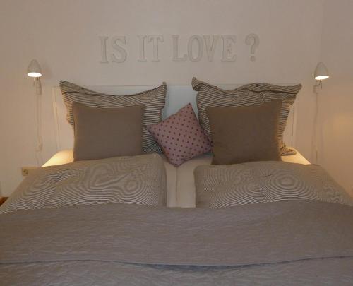 a bed with a sign that reads is it love at Melcher`s in Bernkastel-Kues