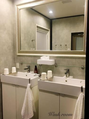 a bathroom with two sinks and a large mirror at 曼 东福寺之 壹 in Kyoto