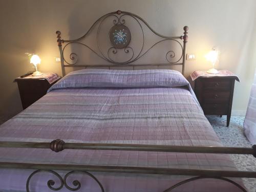 a bedroom with a large bed with two night stands at L'Antico Faro in Castelsardo