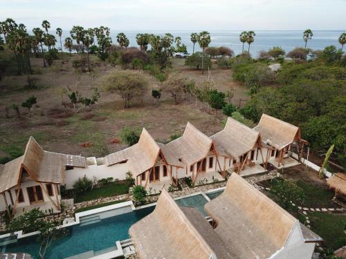 an aerial view of a resort with a swimming pool at Kalyssa Beach Bungalows in Pemuteran