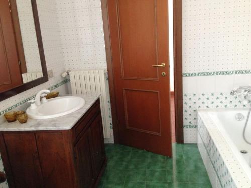 a bathroom with a sink and a toilet and a tub at A casa di Antonella in Biella