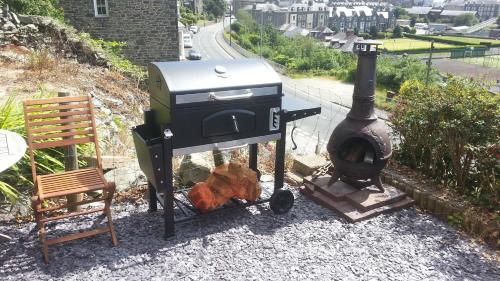 a grill and a wood stove on a patio at Apartment Chic in Barmouth
