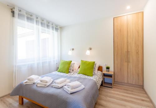 1 dormitorio con 1 cama con almohadas verdes en Apartament i Pokoje Gościnne u Lusi, en Wisła