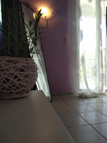 a room with a table with a plant and a window at Rosegarden in Sami