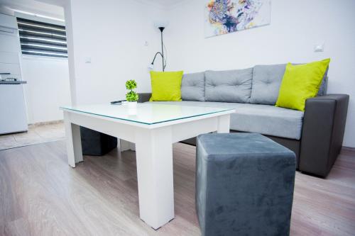 a living room with a table and a couch at Vila Magdalena in Gevgelija