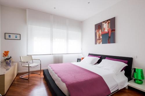 a bedroom with a large bed with a pink blanket at The Jasmine Terrace Retreat in Bologna
