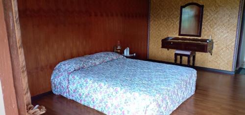 a bedroom with a bed and a sink and a piano at Toraja Torsina Hotel in Rantepao