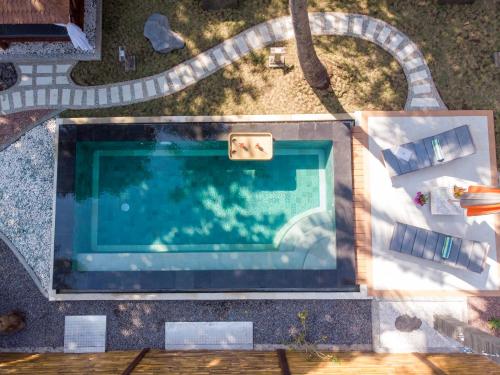 an overhead view of a swimming pool in a yard at Octopus Villas in Tejakula