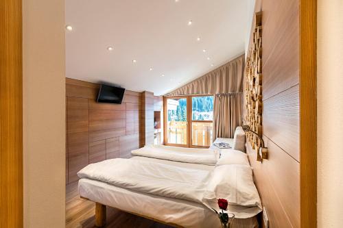 Postel nebo postele na pokoji v ubytování Hotel Dahu