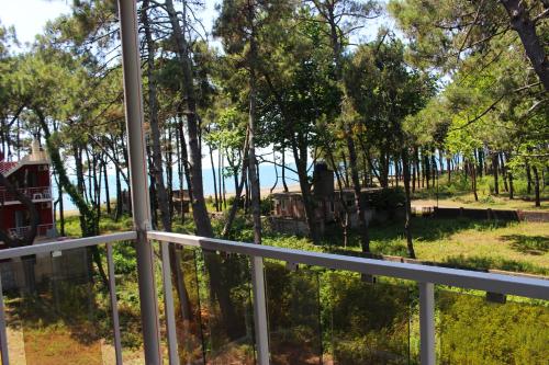 a view from the balcony of a house with trees at New Wave1 in Grigoleti