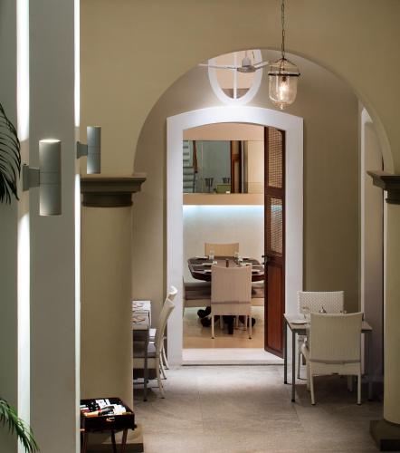 a dining room with a table and a mirror at Villa Shanti - Heritage Hotel for Foodies in Puducherry