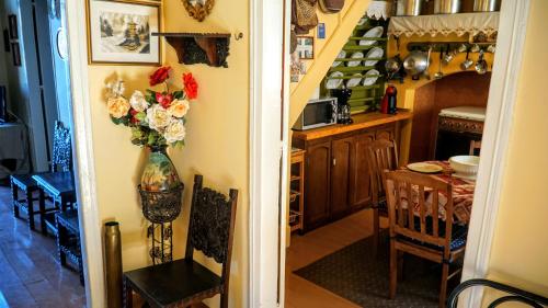 a kitchen and dining room with a vase of flowers on the wall at Moschos Mansion in Symi