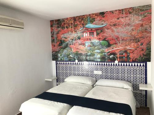 a bedroom with two beds and a painting on the wall at Hotel Playa San Cristóbal in Almuñécar