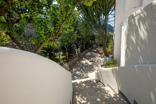 a white fence with trees on the side of a house at Casa Gaia in Capri